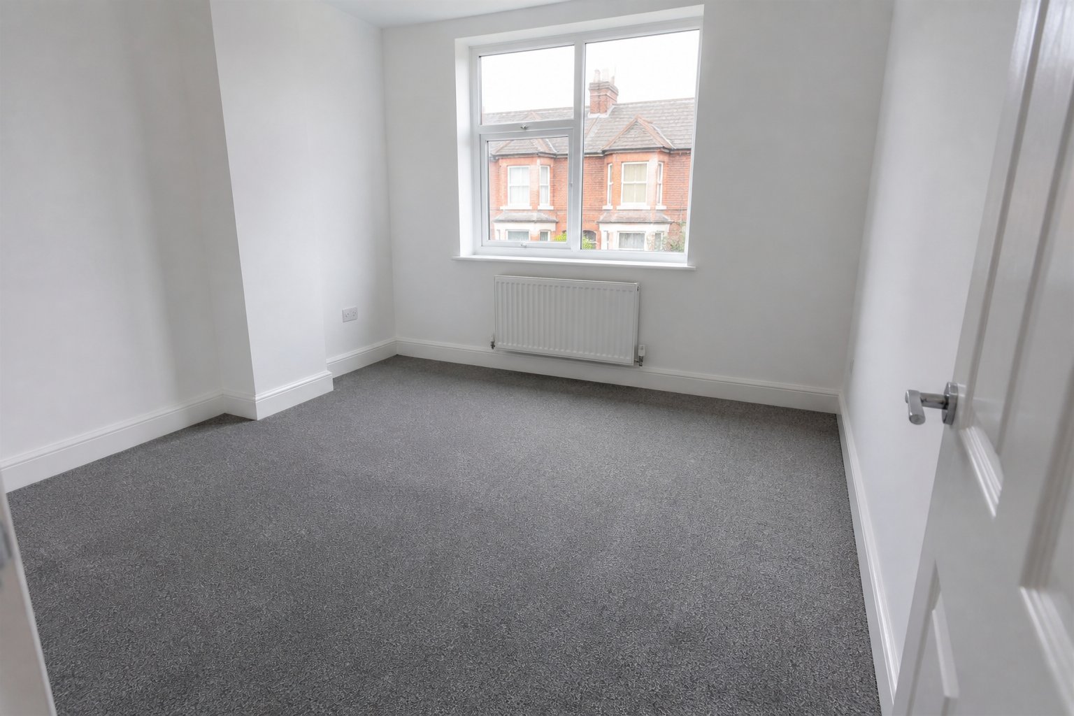 Rental bedroom with hard-wearing grey carpet